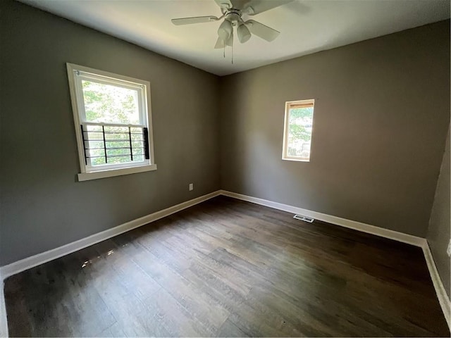 unfurnished room with ceiling fan and dark hardwood / wood-style floors