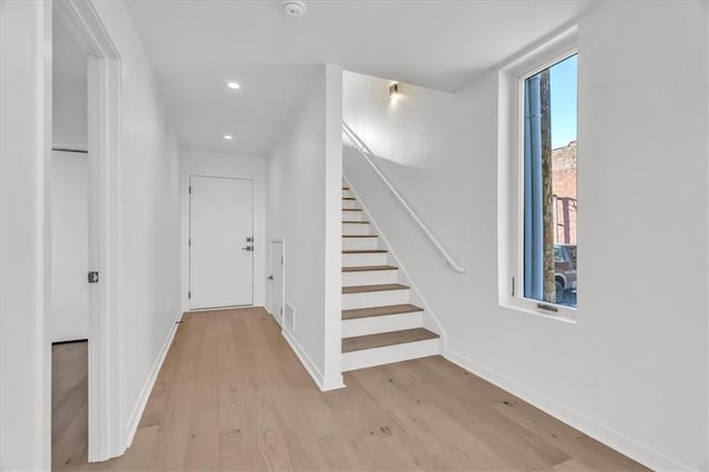 corridor with light hardwood / wood-style floors