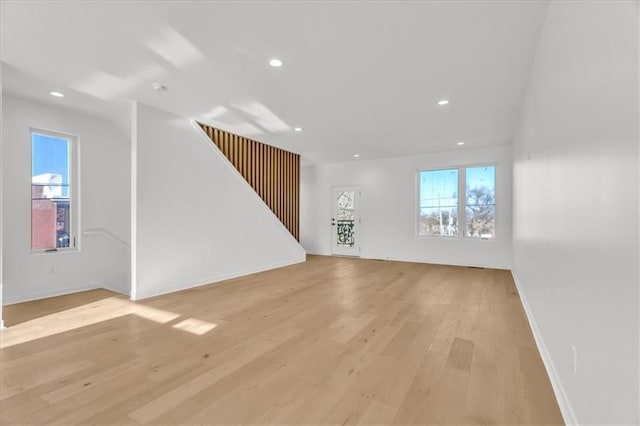 unfurnished living room with plenty of natural light and light hardwood / wood-style flooring