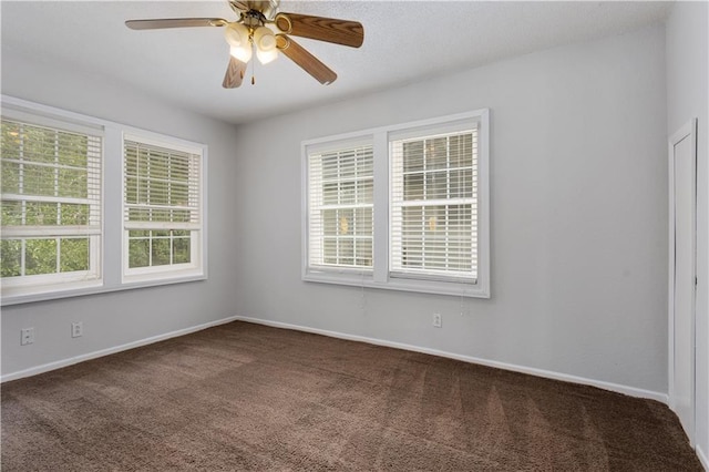 carpeted empty room featuring plenty of natural light and ceiling fan