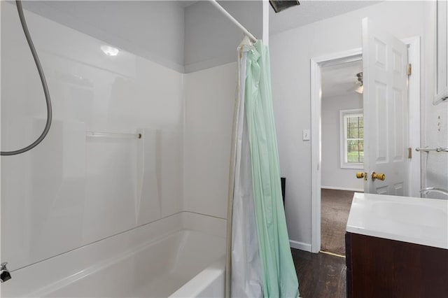 bathroom with shower / bathtub combination with curtain, hardwood / wood-style floors, and vanity