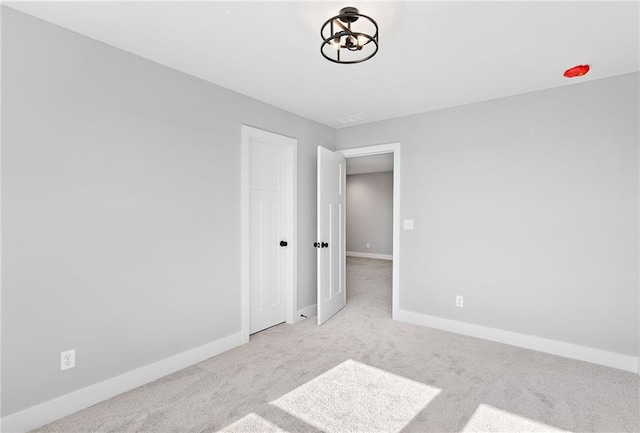 unfurnished room with light colored carpet