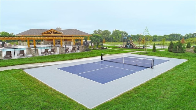 view of sport court with a playground and a lawn