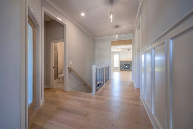 hall featuring crown molding and light hardwood / wood-style flooring