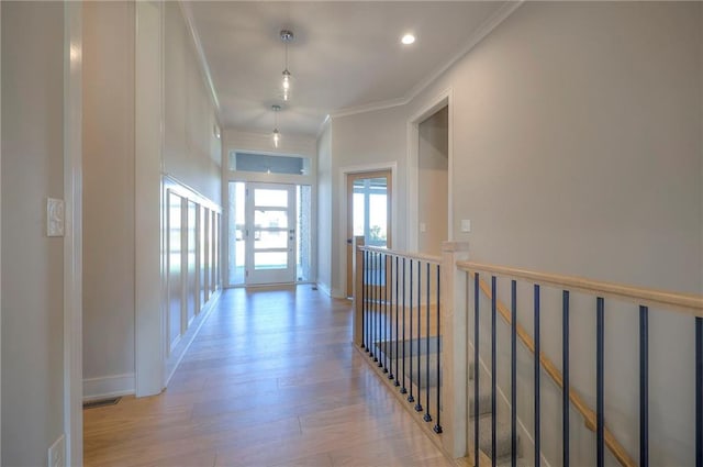 hall featuring crown molding and light hardwood / wood-style floors