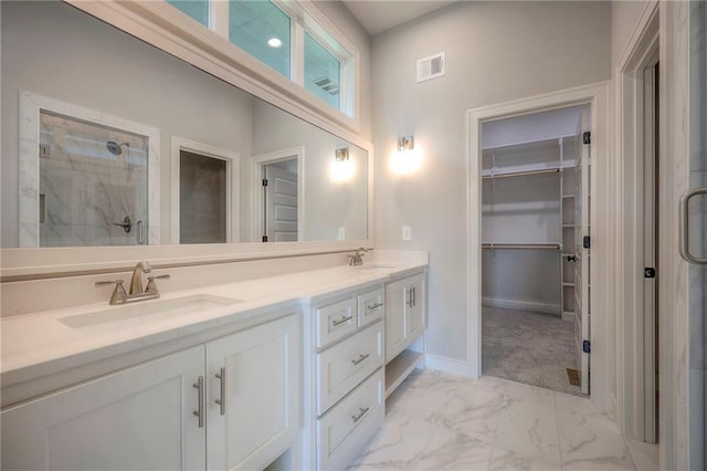 bathroom featuring vanity and a shower with door