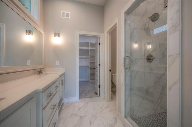 bathroom with vanity, toilet, and walk in shower