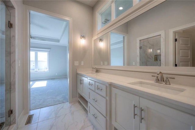 bathroom with a shower with door and vanity