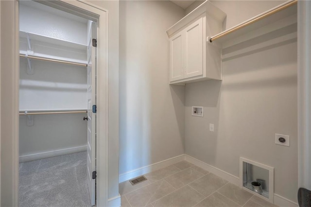 clothes washing area featuring hookup for a washing machine, cabinets, and hookup for an electric dryer