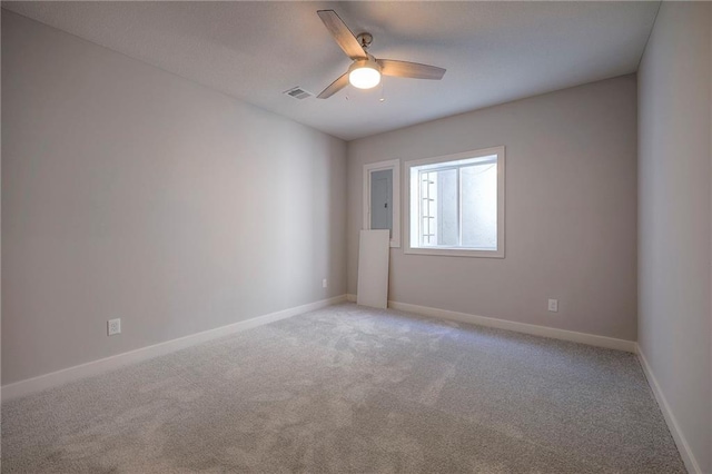 carpeted spare room featuring ceiling fan