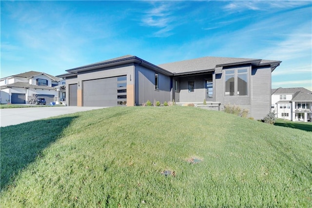 view of front facade with a garage and a front lawn