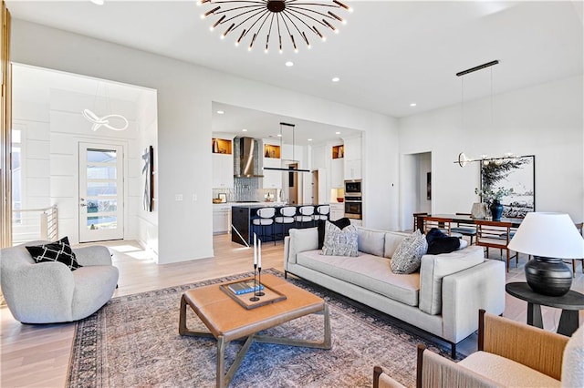 living room featuring light hardwood / wood-style floors and a notable chandelier