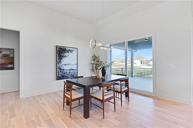 dining room featuring an inviting chandelier and light hardwood / wood-style flooring