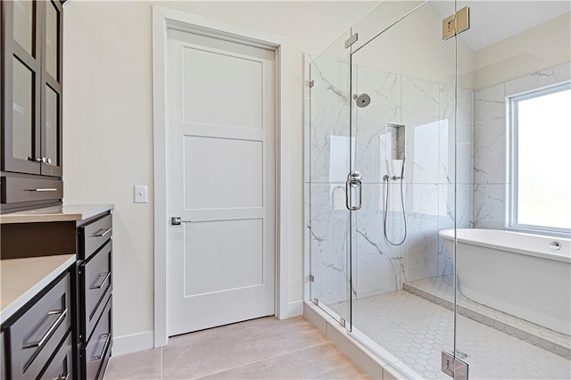 bathroom featuring tile patterned flooring, vanity, plenty of natural light, and a shower with shower door