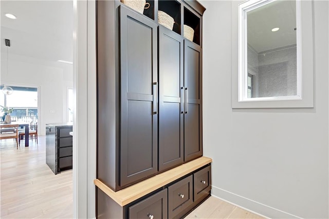 mudroom with light hardwood / wood-style floors