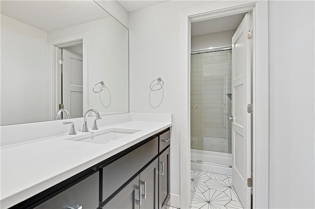 bathroom with vanity, tile patterned floors, and a shower with door