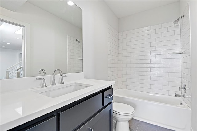 full bathroom featuring vanity, tiled shower / bath combo, tile patterned floors, and toilet