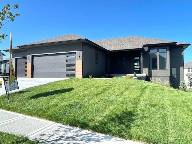 17321 Gillette St, Overland Park, KS 66221 - prairie-style home featuring an attached garage, a front lawn, roof with shingles, and driveway