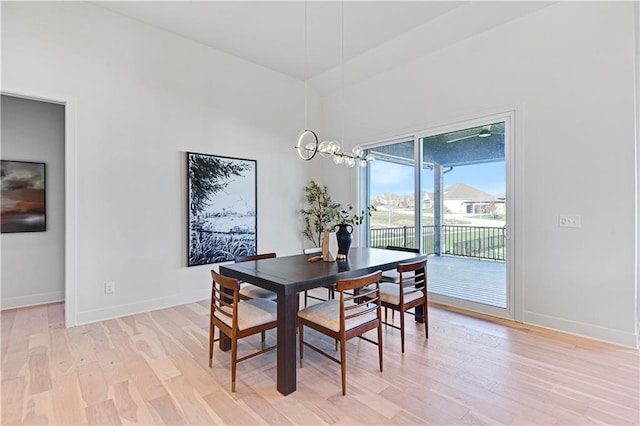 17321 Gillette St, Overland Park, KS 66221 - dining space with light wood-style floors, high vaulted ceiling, and a chandelier