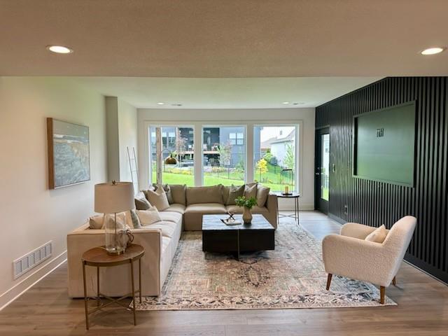 17321 Gillette St, Overland Park, KS 66221 - living area featuring wood finished floors and recessed lighting