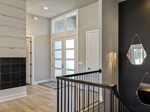 foyer entrance with hardwood / wood-style floors and french doors