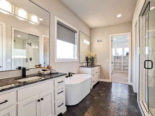 bathroom with vanity and independent shower and bath