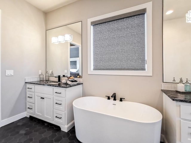 bathroom featuring vanity, tile patterned flooring, and a washtub