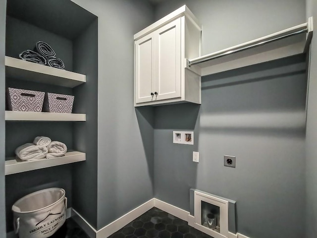 clothes washing area with cabinets, hookup for a washing machine, and hookup for an electric dryer