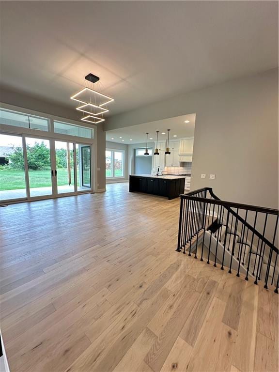 living room featuring light hardwood / wood-style flooring and a notable chandelier