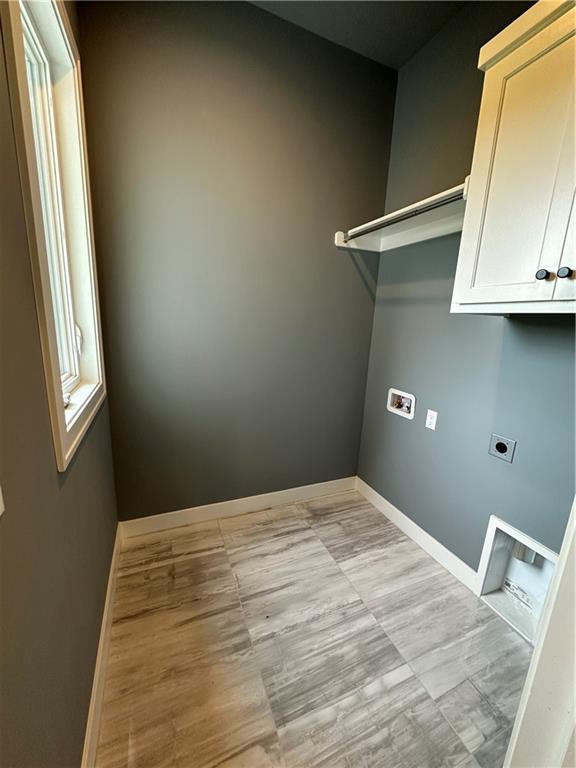 laundry area featuring cabinets, hookup for a washing machine, and electric dryer hookup