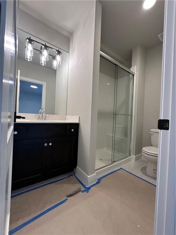 bathroom featuring vanity, toilet, concrete flooring, and a shower with door