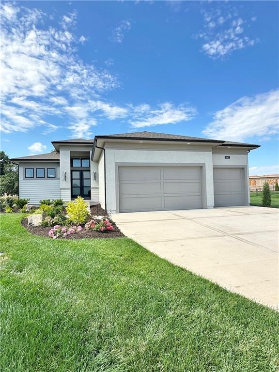 view of front facade with a garage and a front lawn