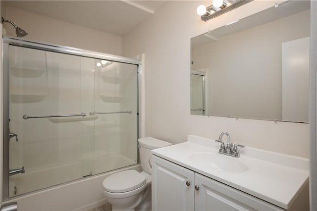 full bathroom featuring large vanity, toilet, and bath / shower combo with glass door