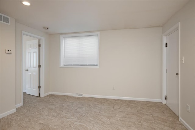 unfurnished room with light tile flooring