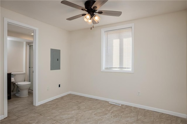 unfurnished bedroom featuring light tile floors, ceiling fan, and ensuite bathroom