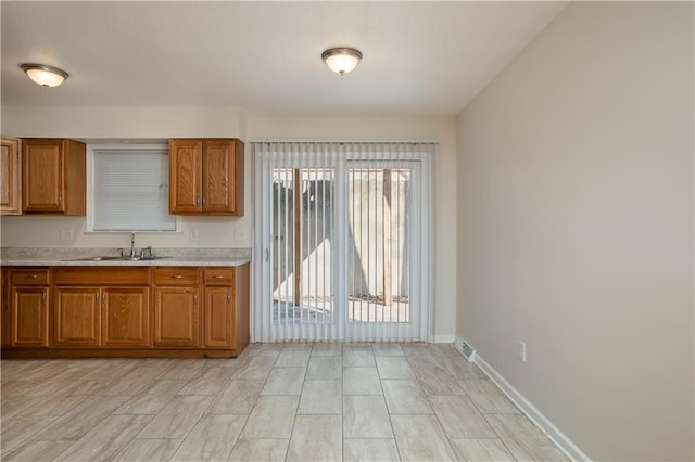 kitchen featuring sink and light stone counters