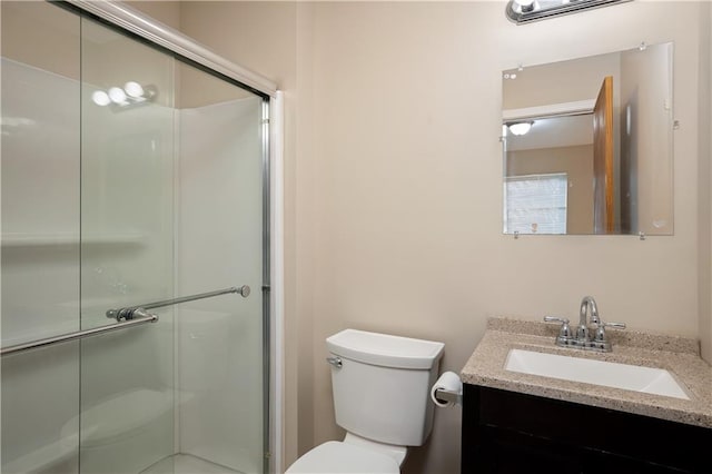 bathroom with walk in shower, toilet, and vanity