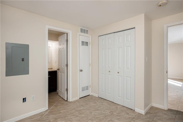 unfurnished bedroom featuring a closet and light tile flooring