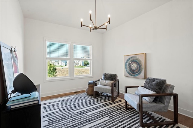 11522 S Zarda Dr, Olathe, KS 66061 - sitting room with lofted ceiling, a notable chandelier, wood finished floors, and baseboards