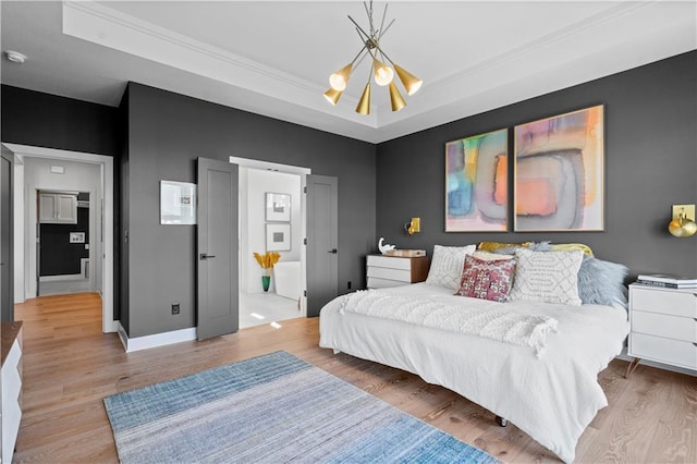 11522 S Zarda Dr, Olathe, KS 66061 - bedroom with wood finished floors, a chandelier, a tray ceiling, and baseboards