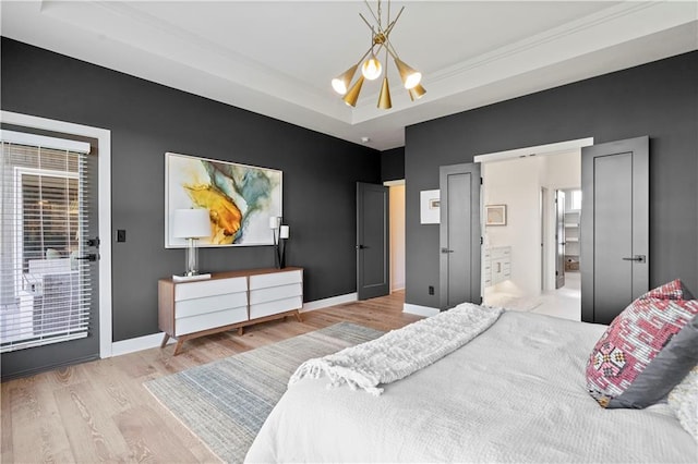 11522 S Zarda Dr, Olathe, KS 66061 - bedroom featuring a chandelier, baseboards, wood finished floors, and a raised ceiling
