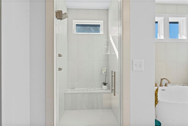 11522 S Zarda Dr, Olathe, KS 66061 - full bathroom featuring a freestanding tub, a stall shower, and tile walls