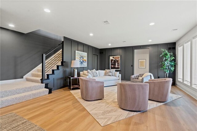 11522 S Zarda Dr, Olathe, KS 66061 - living area featuring light wood-style flooring, visible vents, recessed lighting, a decorative wall, and stairs