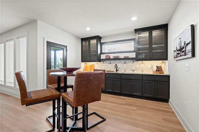 11522 S Zarda Dr, Olathe, KS 66061 - interior space with wet bar, recessed lighting, light wood finished floors, and decorative backsplash
