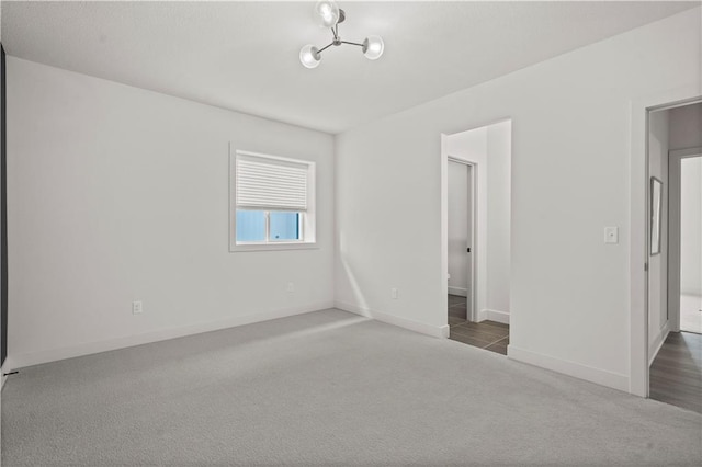 11522 S Zarda Dr, Olathe, KS 66061 - carpeted empty room with an inviting chandelier and baseboards
