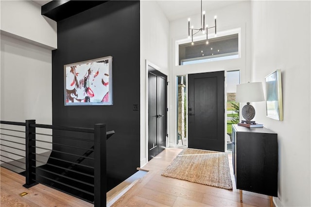 11522 S Zarda Dr, Olathe, KS 66061 - entrance foyer featuring wood finished floors, an inviting chandelier, and a towering ceiling