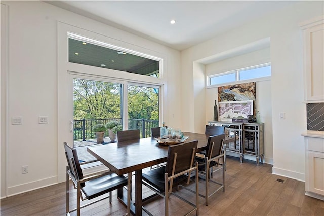 dining space with dark wood-type flooring