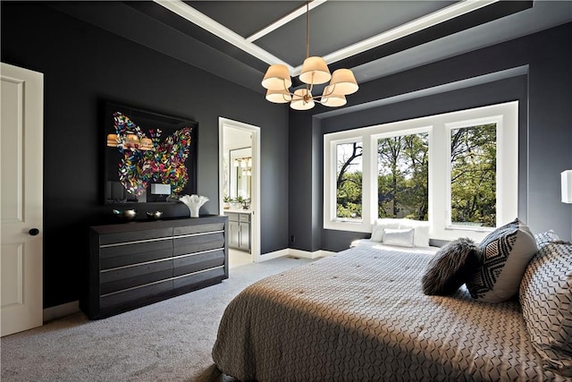 carpeted bedroom with a chandelier, a raised ceiling, and ensuite bathroom