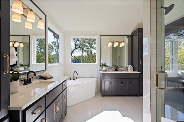 bathroom with double sink vanity, tile flooring, and independent shower and bath