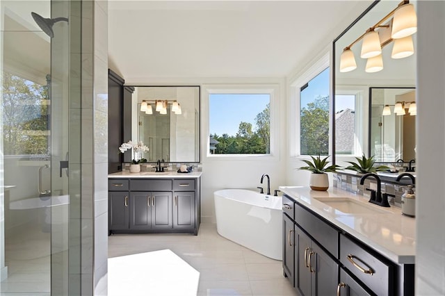 bathroom with shower with separate bathtub, double sink, large vanity, and tile flooring